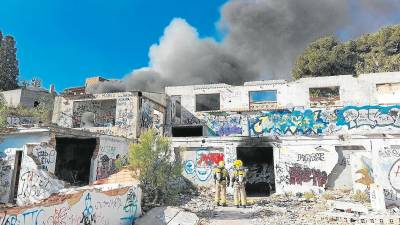 Los bomberos, trabajando en sofocar el incendio en la fábrica en ruinas. Foto: Bombers