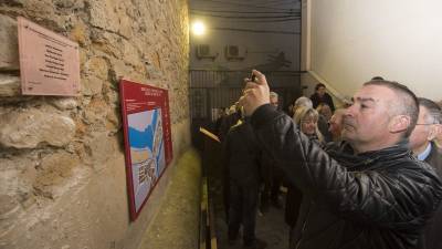 L´alcalde de Flix, Marc Mur, fa una fotografia de la nova placa amb el nom de les víctimes. Foto: JOAN REVILLAS