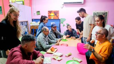 Un grupo de miembros del Club Social La Muralla, ubicado en el Carrer Sant Miquel, esta semana preparando panellets. Foto: Alba Mariné