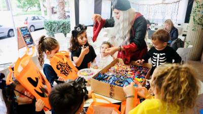 Un grupo de niños y niñas, con su bolsa de Salouween, en busca de su recompensa en la cafetería The Garden Café. foto: Alba Mariné