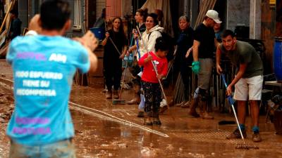 Varias personas limpiando el barrio de La Torre de Valencia afectado por la DANA. Foto: Arnau Martínez/Mar Rovira (ACN)