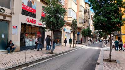 La calle Prat de la Riba de Reus, este lunes sobre las 12 h, con la mayoría de negocios cerrados y gente paseando. FOTO: M.P.