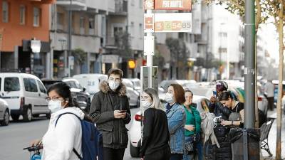 Usuarios de la EMT, ayer, esperando en una parada de la calle Pere Martell. Foto: Pere Ferré