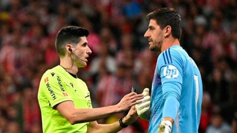 El árbitro Mateo Busquets hablando con el portero del Real Madrid, Thibaut Courtois. Foto: EFE