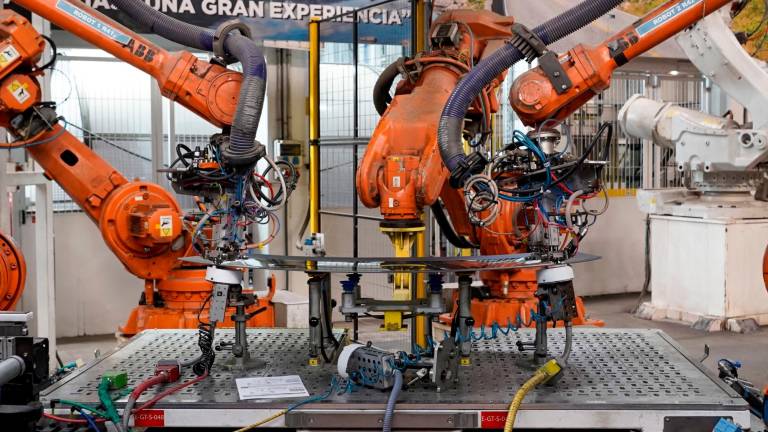Robots industriales trabajando en las soldaduras de una luneta térmica. Foto: Marc Bosch