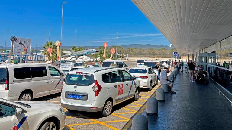 Taxistas esperando que salgan los viajeros delante del aeropuerto de Reus. foto: Alfredo González