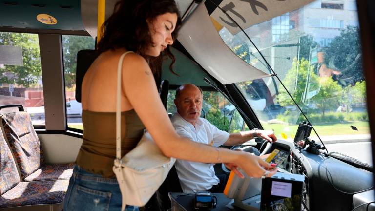 Una pasajera pasando la tarjeta por la máquina del autobús del servicio a demanda BusxTu, el que quieren tener los vecinos. Foto: Alba Mariné