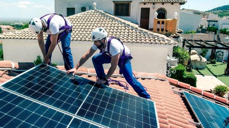 Operarios instalando placas solares en el tejado de una casa. Foto: DT