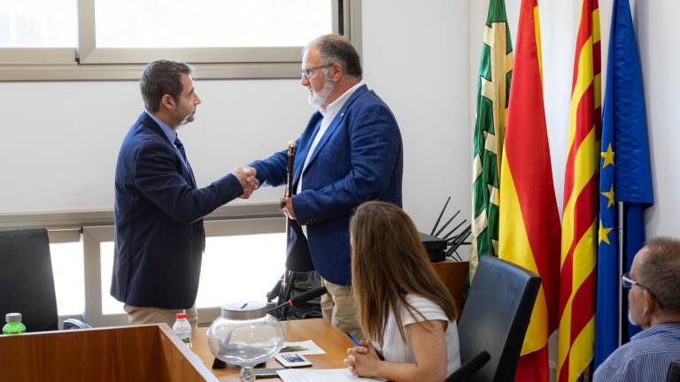 El nuevo alcalde, Jordi Sans (PSC), recoge la vara de manos del alcalde saliente, Xavier Marcos (FIC). Foto: Àngel Ullate
