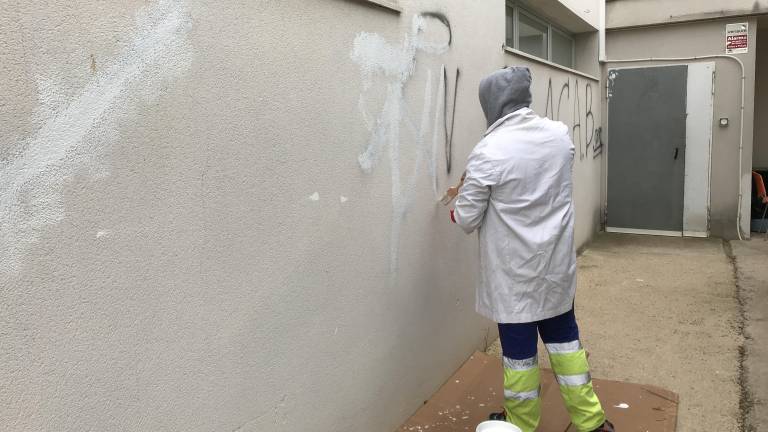 Imagen del autor de las marcas repintando la pared del edificio de La Muntanyeta durante la semana pasada. Foto: Cedida